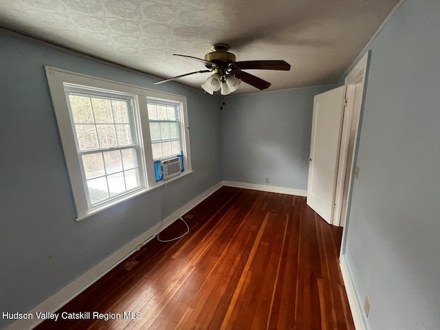 unfurnished room with ceiling fan, cooling unit, and dark wood-type flooring