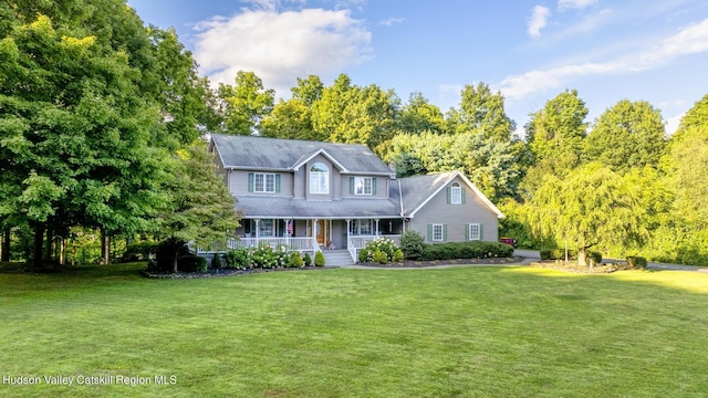 colonial-style house featuring a front yard and a porch