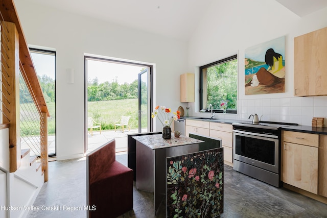 1114 County Route 3, Ancram, NY 12502 - kitchen with stainless steel appliances, concrete flooring, light brown cabinets, vaulted ceiling, and a kitchen island