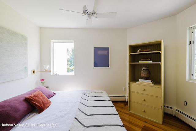 1114 County Route 3, Ancram, NY 12502 - bedroom featuring a baseboard heating unit, multiple windows, and wood finished floors