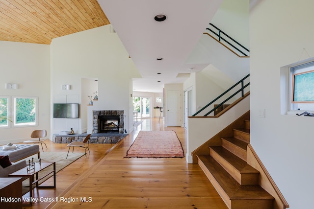 1114 County Route 3, Ancram, NY 12502 - living area featuring hardwood / wood-style flooring, stairway, a towering ceiling, and a fireplace