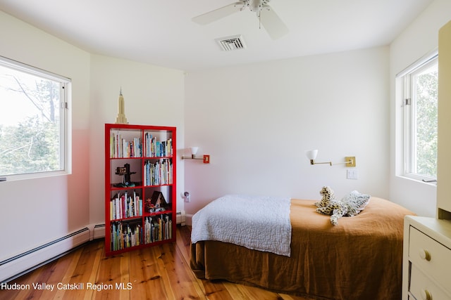1114 County Route 3, Ancram, NY 12502 - bedroom featuring baseboard heating, light wood-type flooring, and a ceiling fan