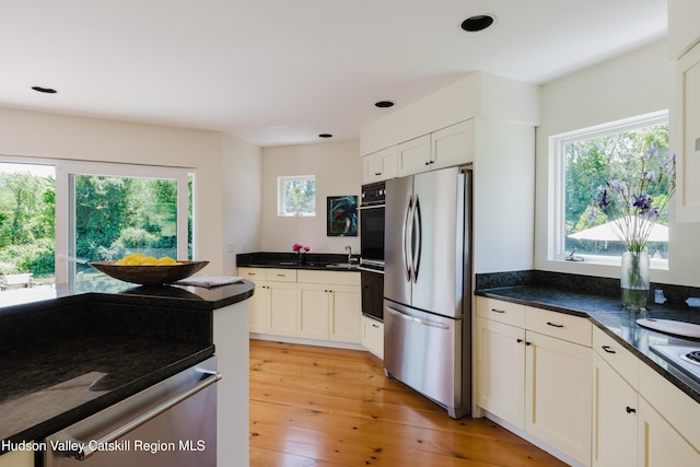 1114 County Route 3, Ancram, NY 12502 - kitchen with appliances with stainless steel finishes, dark countertops, light wood finished floors, white cabinets, and recessed lighting
