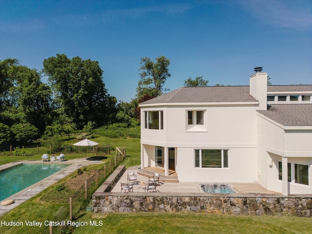 1114 County Route 3, Ancram, NY 12502 - rear view of house with a patio, a chimney, a lawn, and a shingled roof