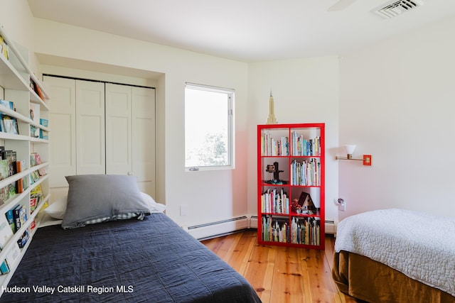 1114 County Route 3, Ancram, NY 12502 - bedroom featuring baseboard heating, light wood-style floors, and a closet