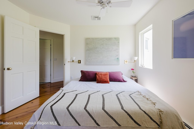 1114 County Route 3, Ancram, NY 12502 - bedroom with a baseboard heating unit, wood finished floors, and ceiling fan
