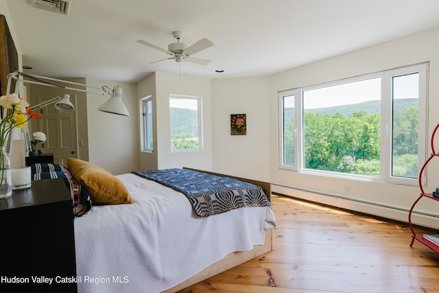 1114 County Route 3, Ancram, NY 12502 - bedroom featuring a baseboard heating unit, hardwood / wood-style flooring, and ceiling fan