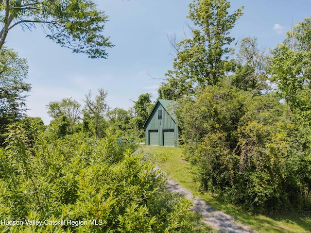 1114 County Route 3, Ancram, NY 12502 - view of yard featuring a detached garage, dirt driveway, and an outdoor structure