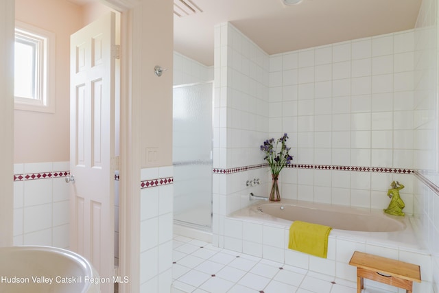 1114 County Route 3, Ancram, NY 12502 - bathroom featuring tile walls, a shower stall, a bath, and tile patterned floors