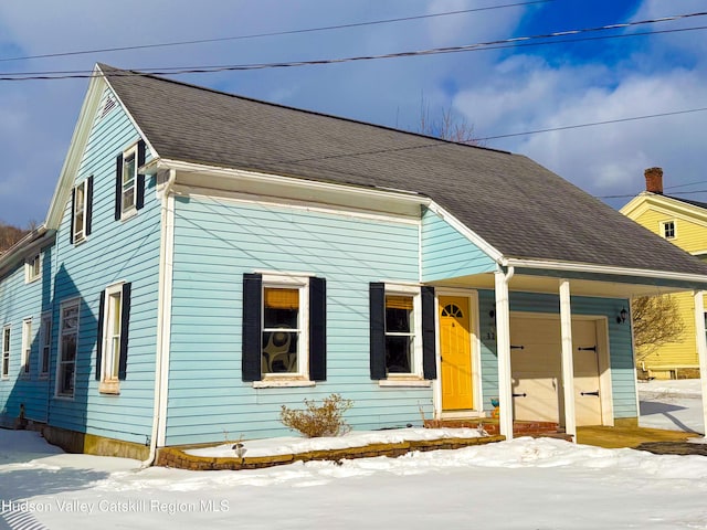 view of front of property featuring roof with shingles