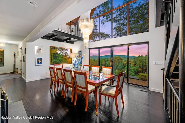dining room featuring dark hardwood / wood-style flooring and an inviting chandelier