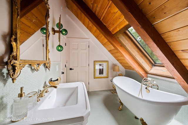 bathroom with a bathing tub, lofted ceiling with skylight, and wooden ceiling