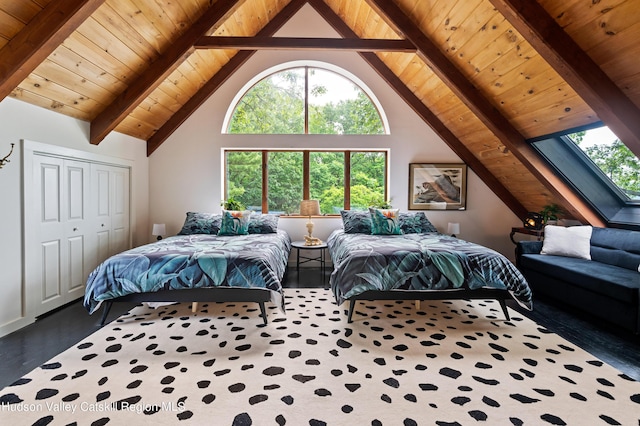 bedroom with wooden ceiling, high vaulted ceiling, a skylight, beam ceiling, and a closet
