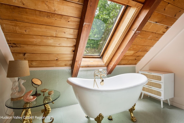 bathroom featuring lofted ceiling, a bath, and wood ceiling