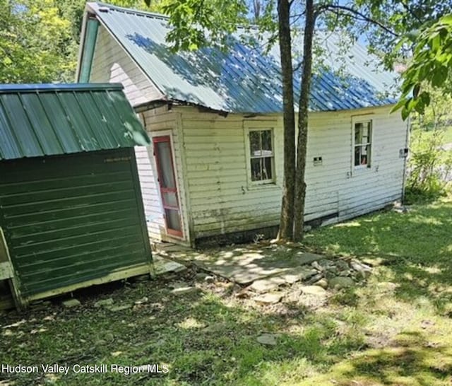 exterior space with a shed and a lawn