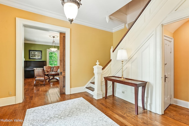 125 Bedell Rd, Poughkeepsie Town, NY 12603 - hall featuring stairs, crown molding, and wood finished floors