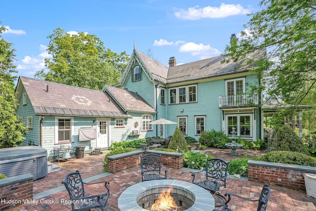 125 Bedell Rd, Poughkeepsie Town, NY 12603 - back of property featuring an outdoor fire pit, a hot tub, a patio area, a chimney, and a balcony