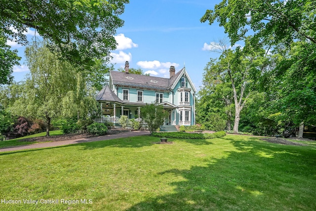 125 Bedell Rd, Poughkeepsie Town, NY 12603 - rear view of house featuring a lawn, a chimney, and a porch