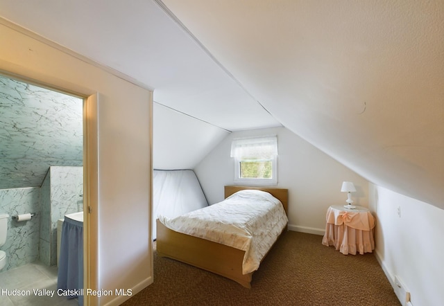 carpeted bedroom with lofted ceiling