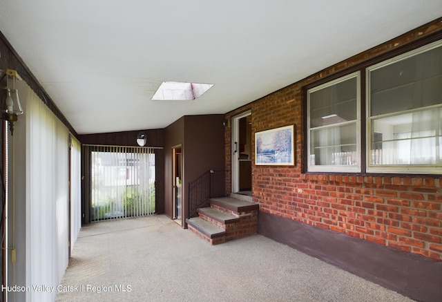 interior space with lofted ceiling with skylight