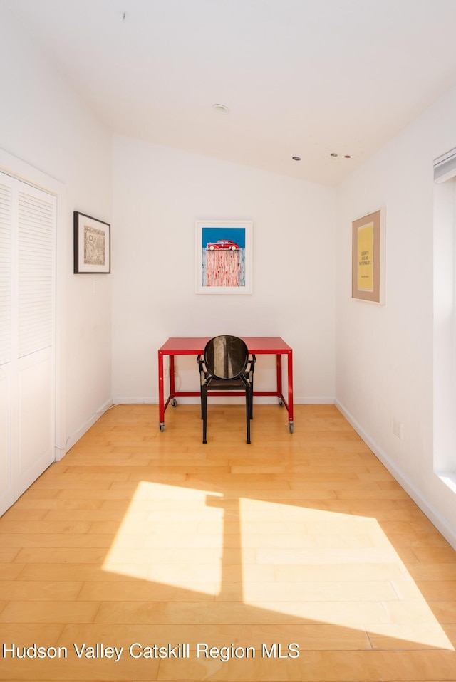 sitting room with baseboards and wood finished floors