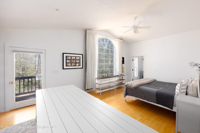 bedroom featuring access to outside, multiple windows, and light wood finished floors