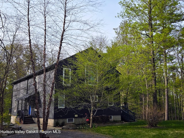 view of side of home featuring a lawn