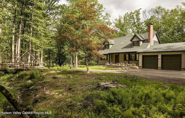 55 Ginger Rd, High Falls, NY 12440 - view of front facade featuring asphalt driveway, a garage, a chimney, and covered porch
