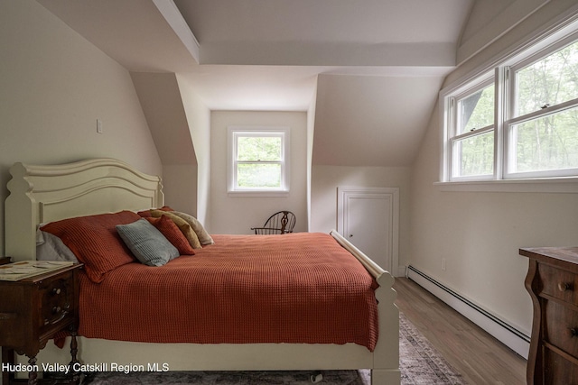 55 Ginger Rd, High Falls, NY 12440 - bedroom with a baseboard heating unit, wood finished floors, and vaulted ceiling