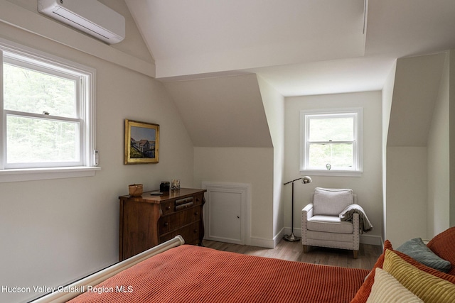 55 Ginger Rd, High Falls, NY 12440 - bedroom with a wall mounted air conditioner, vaulted ceiling, wood finished floors, and baseboards