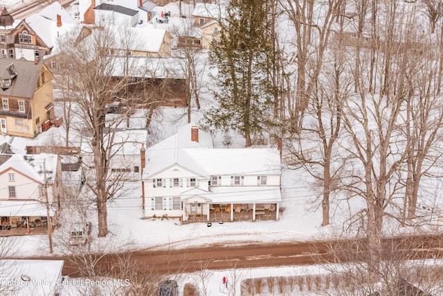 snowy aerial view featuring a residential view