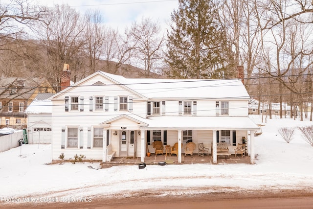 view of front of property featuring covered porch and a chimney