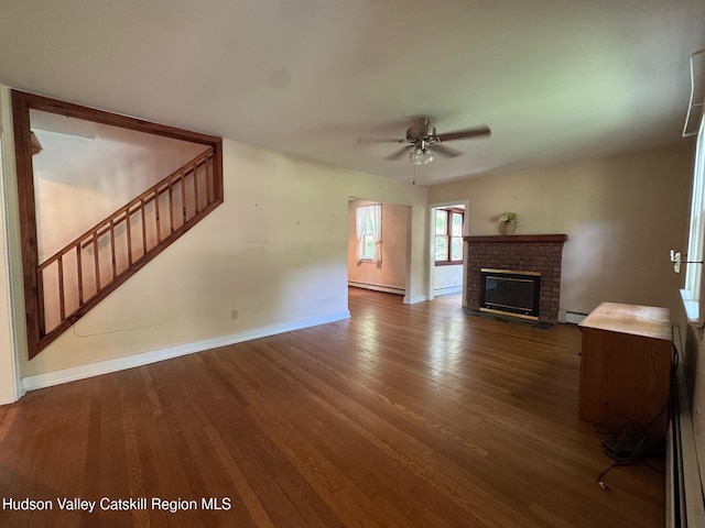 50 Payn Ave, Chatham, NY 12037 - unfurnished living room featuring stairs, wood finished floors, a baseboard heating unit, and ceiling fan