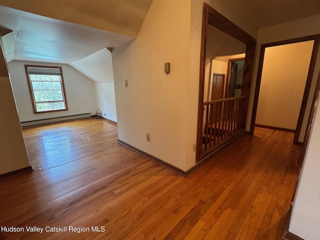 50 Payn Ave, Chatham, NY 12037 - additional living space with baseboard heating, wood-type flooring, and lofted ceiling