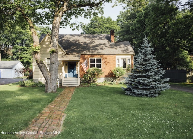 50 Payn Ave, Chatham, NY 12037 - view of front of property with a chimney, brick siding, and an outdoor structure