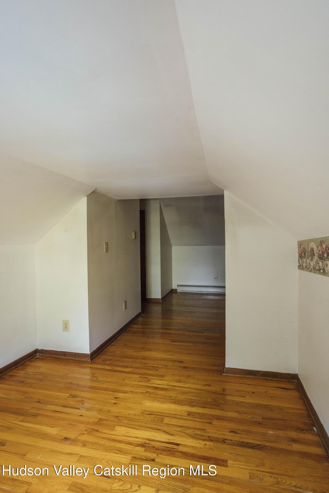 50 Payn Ave, Chatham, NY 12037 - bonus room featuring lofted ceiling, baseboard heating, and wood finished floors