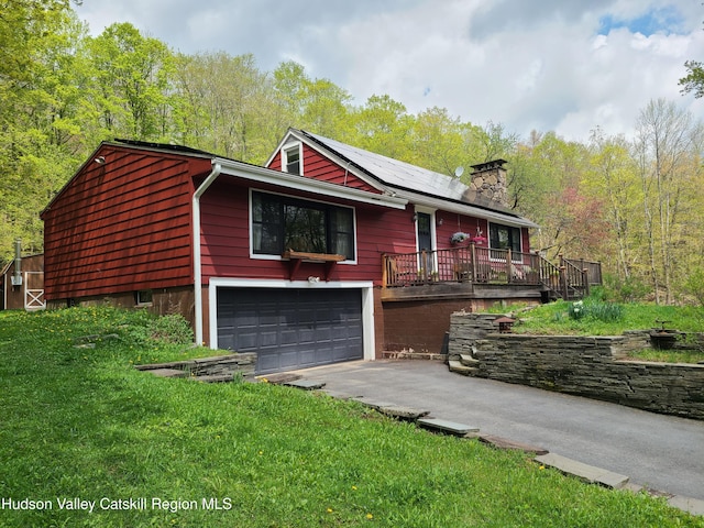 223 Church Rd, Livingston Manor, NY 12758 - ranch-style home with a garage, driveway, a chimney, and roof mounted solar panels