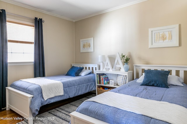 bedroom featuring wood finished floors and ornamental molding