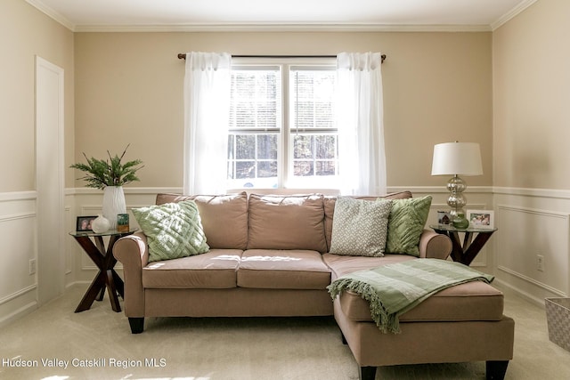 living area with a wainscoted wall, carpet floors, and ornamental molding