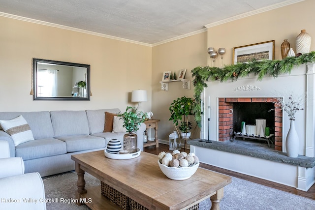 living room featuring crown molding, a brick fireplace, wood finished floors, and baseboards