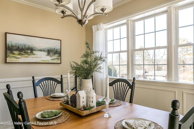 dining area featuring a chandelier and ornamental molding