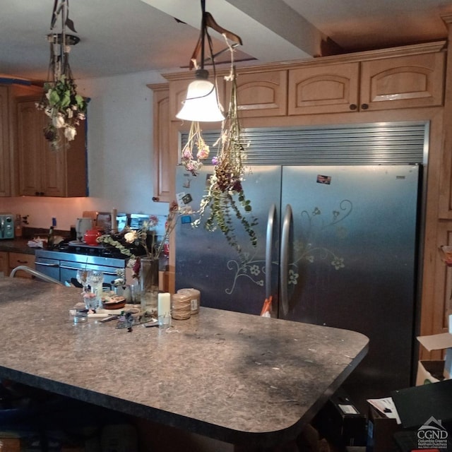 kitchen with stainless steel built in refrigerator, decorative light fixtures, and a center island