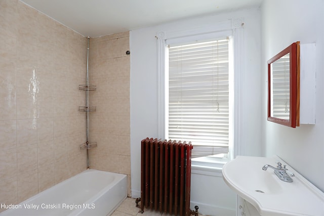 full bathroom with radiator heating unit, a sink, and tub / shower combination