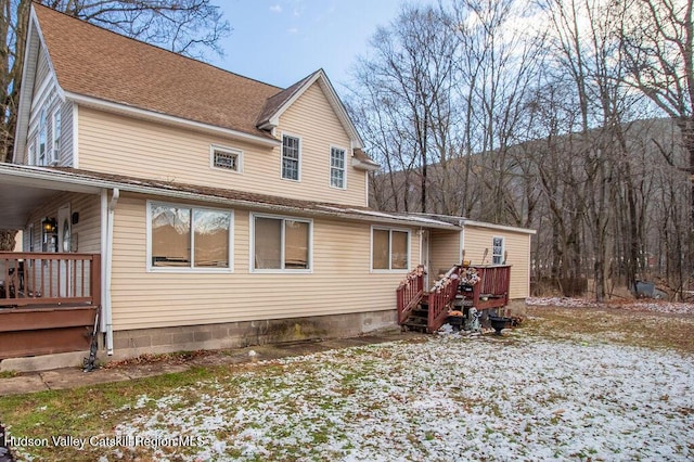 back of house with a deck