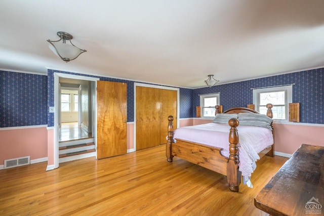 2 W Marie St, Hudson, NY 12534 - bedroom featuring wallpapered walls, multiple windows, light wood finished floors, baseboards, and crown molding