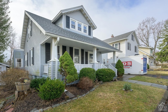 2 W Marie St, Hudson, NY 12534 - view of front of property with covered porch, roof with shingles, and a front yard