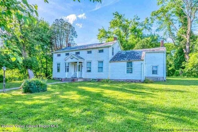 colonial-style house with a front yard