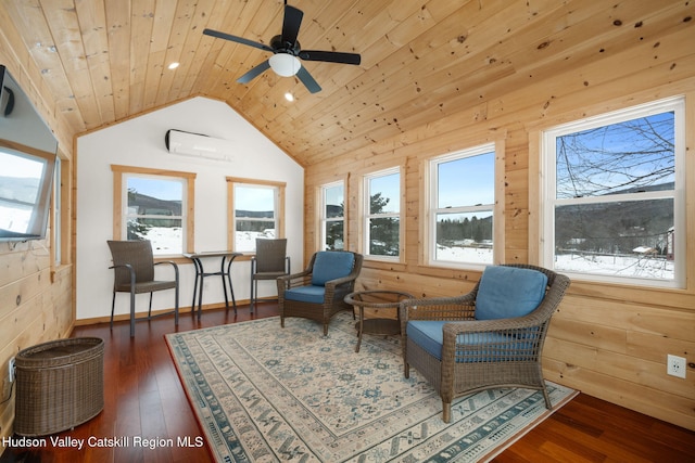 sitting room featuring ceiling fan, wooden walls, dark wood-type flooring, an AC wall unit, and wooden ceiling