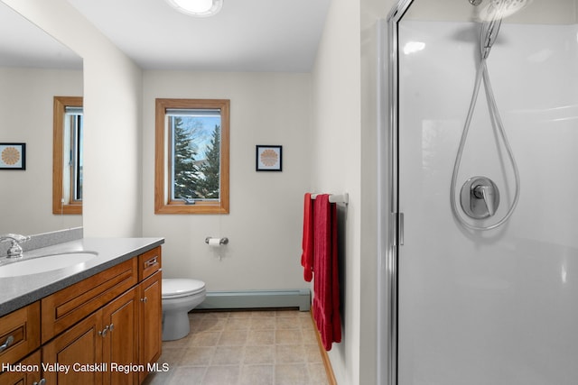 bathroom featuring vanity, toilet, a shower with door, and a baseboard radiator