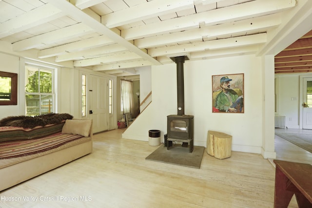 1130 Sawkill Rd, Kingston, NY 12401 - living area with radiator heating unit, a wood stove, light wood finished floors, beam ceiling, and baseboards